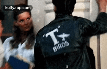A Man Wearing A Leather Jacket With The Word Birds On It . GIF