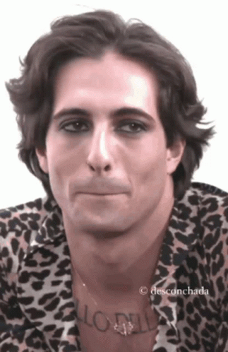 A Man Wearing A Leopard Print Shirt Has A Tattoo On His Neck That Says ' Aloha ' GIF