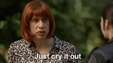 A Man Wearing A Leopard Print Shirt Is Talking To A Woman . GIF