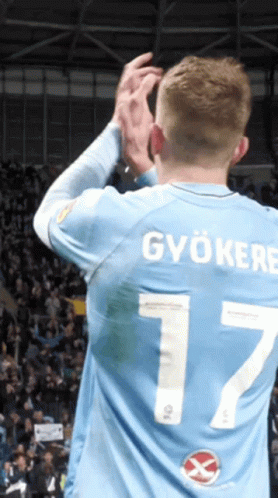 A Man Wearing A Light Blue Jersey With The Number 7 On The Back GIF