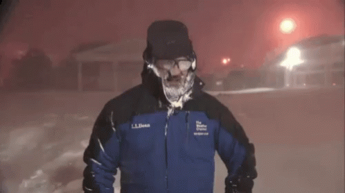 A Man Wearing A Ll Bean Jacket Stands In The Snow GIF