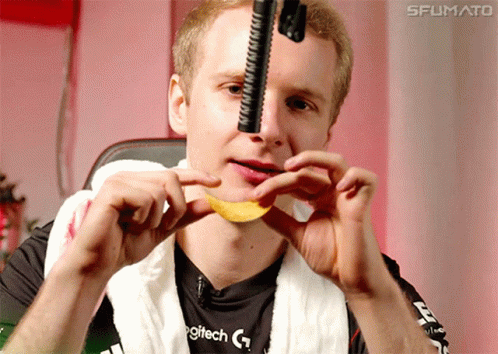 A Man Wearing A Logitech Shirt Is Holding A Chip In His Mouth GIF