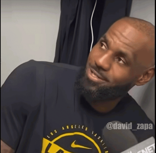 a man wearing a los angeles t-shirt is smiling
