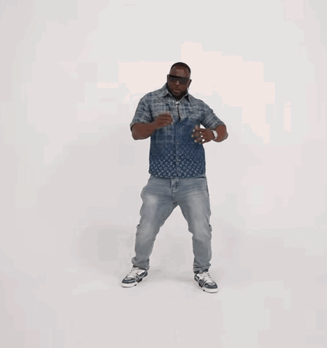 A Man Wearing A Louis Vuitton Shirt And Jeans Is Dancing GIF