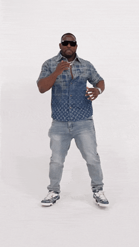 A Man Wearing A Louis Vuitton Shirt And Jeans Is Dancing GIF