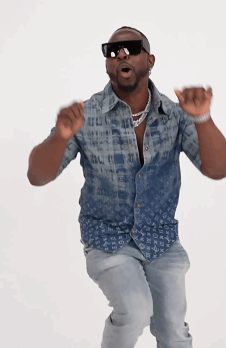 A Man Wearing A Louis Vuitton Shirt Is Dancing GIF