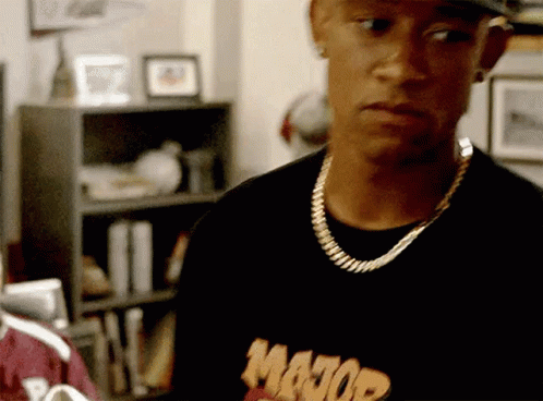 A Man Wearing A Major Shirt And A Gold Chain Around His Neck GIF