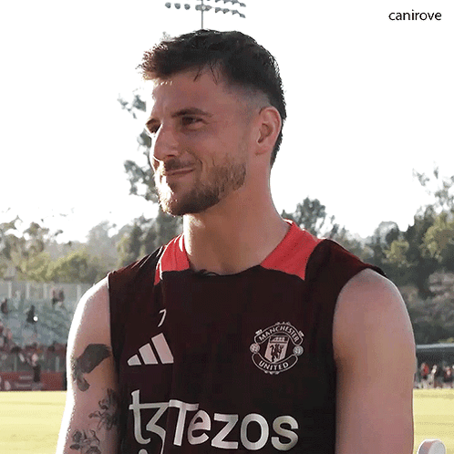 A Man Wearing A Manchester United Jersey Looks At The Camera GIF