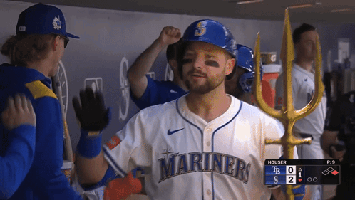 A Man Wearing A Mariners Jersey High Fives Another Man GIF