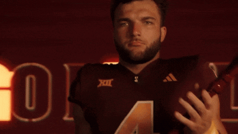 a man wearing a maroon jersey with the number four on it