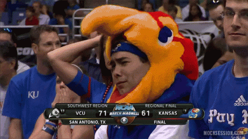 A Man Wearing A Mascot Hat Watches A Basketball Game GIF