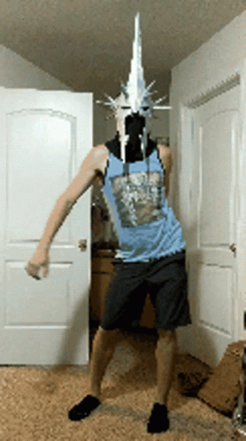 A Man Wearing A Mask And A Blue Tank Top Is Standing In Front Of A Door GIF