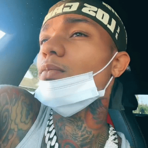 A Man Wearing A Mask And A Headband That Says ' Mad 20J ' On It GIF