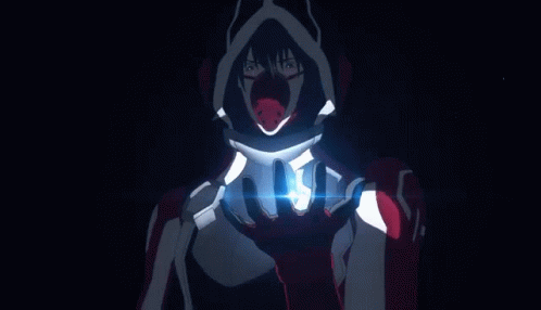 A Man Wearing A Mask And A Hood With Wings Is Standing In Front Of A Feathered Background . GIF