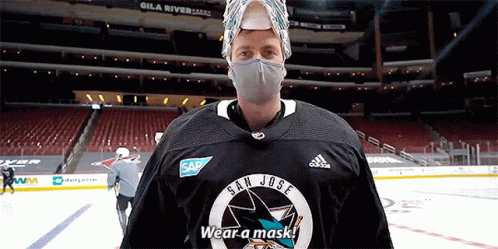 a man wearing a mask and a jersey that says san jose