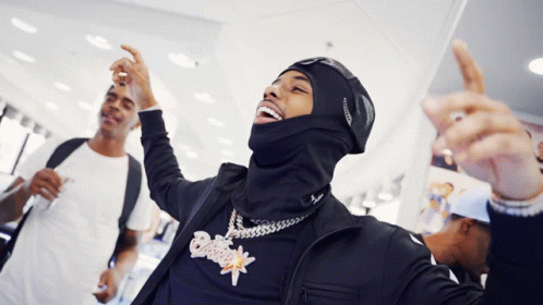 A Man Wearing A Mask And A Necklace With A Pendant That Says ' Snoop Dogg ' On It GIF