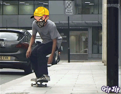 A Man Wearing A Mask And A Yellow Hat Is Riding A Skateboard In Front Of A Thrasher Sign GIF