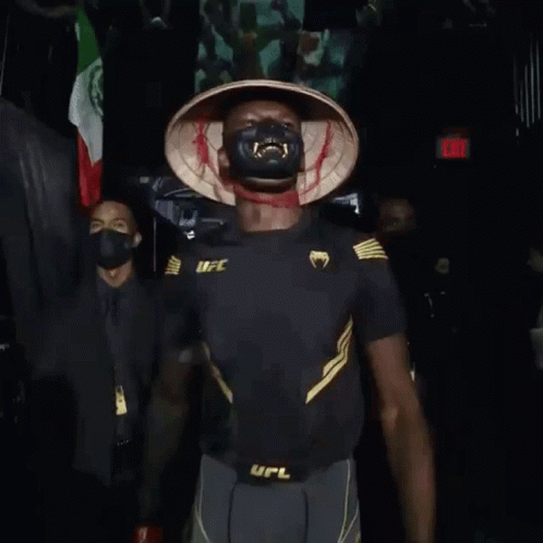 A Man Wearing A Mask And Gloves With The Word Ufc On His Belt GIF