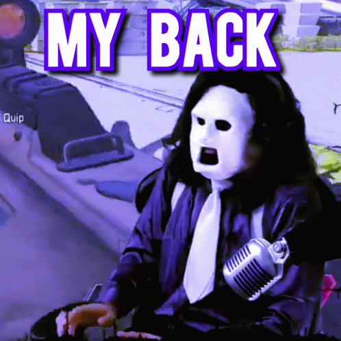 A Man Wearing A Mask Is Sitting In Front Of A Microphone With The Words My Back Above Him GIF