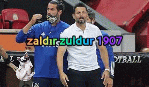 A Man Wearing A Mask Is Standing Next To Another Man Holding A Dog . GIF