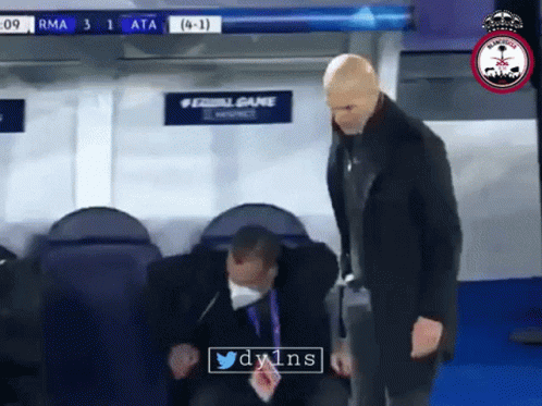 A Man Wearing A Mask Stands Next To Another Man In A Locker Room With A Sign That Says #Equalgame GIF