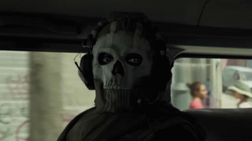 A Man Wearing A Mask With A Skull On It GIF