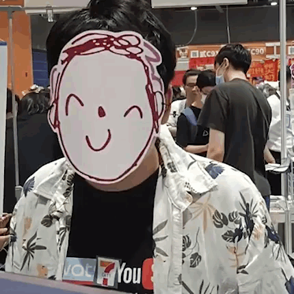 A Man Wearing A Mask With A Smile On It Is Standing In Front Of A Crowd Of People . GIF