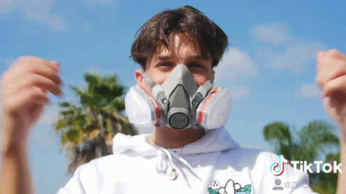 A Man Wearing A Mask With A Tiktok Logo On The Bottom Right GIF