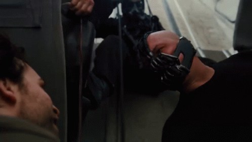 A Man Wearing A Mask With The Words The Fire Rises On The Bottom GIF