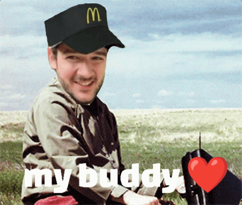 A Man Wearing A Mcdonald 'S Hat Is Sitting In The Grass GIF
