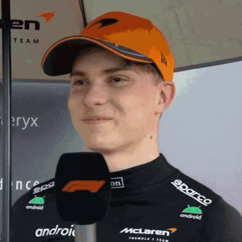 A Man Wearing A Mclaren Hat And A Black Shirt GIF