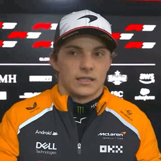 A Man Wearing A Mclaren Jacket And A Dell Jacket GIF