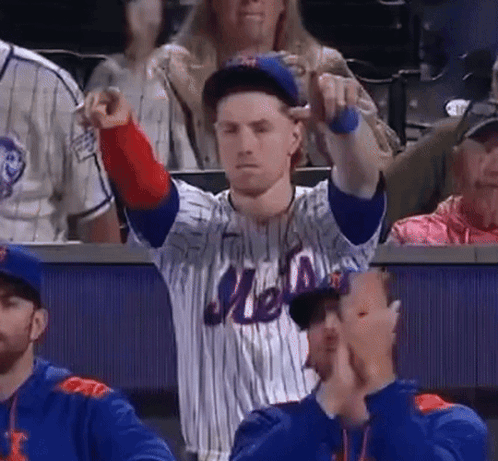A Man Wearing A Mets Jersey Is Pointing At Something GIF