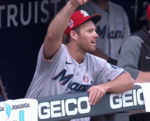 A Man Wearing A Miami Baseball Jersey Stands In The Dugout GIF