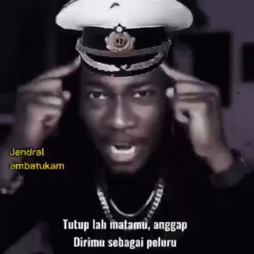 A Man Wearing A Military Hat With The Words " Tutup Lah Matamu , Anggap Dirimu Sebagai Peluru " On The Bottom GIF
