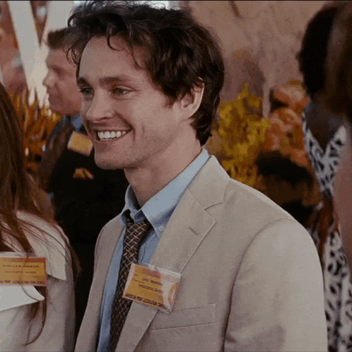 A Man Wearing A Name Tag That Says Chris Morgan On It GIF
