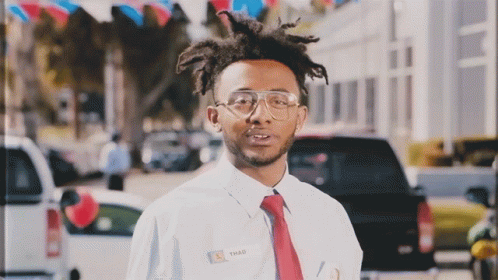 A Man Wearing A Name Tag That Says Shad GIF