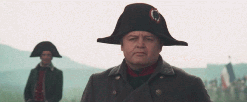 A Man Wearing A Napoleon Hat Stands In Front Of Another Man Wearing A Napoleon Hat GIF