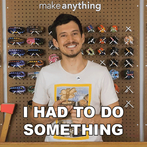 A Man Wearing A National Geographic Shirt Says " I Had To Do Something " In Front Of A Wall Of Hair Clips GIF