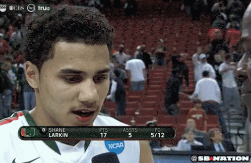 A Man Wearing A Ncaa Jersey Is Talking To A Reporter GIF
