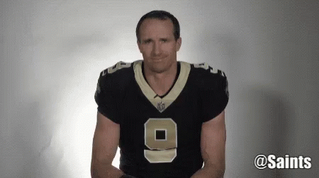 A Man Wearing A New Orleans Saints Jersey Is Making A Face . GIF