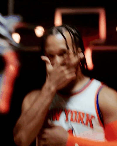 A Man Wearing A New York Jersey Covering His Face With His Hand GIF