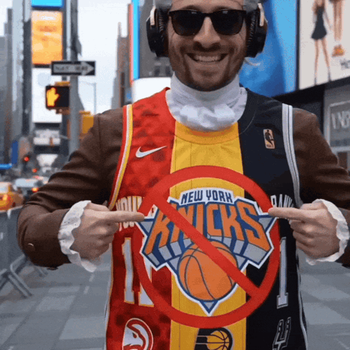A Man Wearing A New York Knicks Jersey Points To A Red Circle GIF