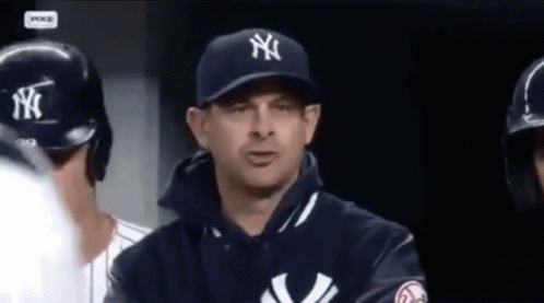 A Man Wearing A New York Yankees Hat And Jacket GIF