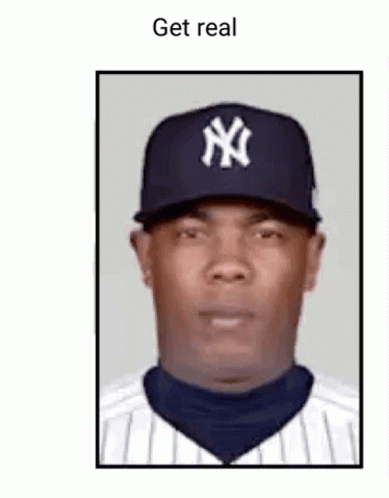 A Man Wearing A New York Yankees Hat And Striped Shirt Is Looking At The Camera . GIF