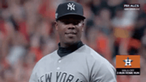 A Man Wearing A New York Yankees Jersey Stands On A Baseball Field GIF