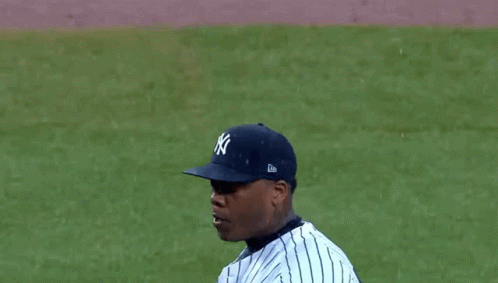 A Man Wearing A New York Yankees Jersey With His Mouth Wide Open GIF