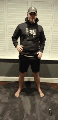 A Man Wearing A Nike Hoodie And A Ny Hat GIF