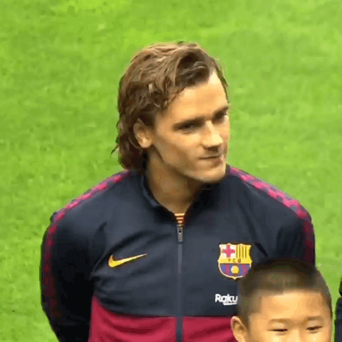 A Man Wearing A Nike Jacket With A Fc Barcelona Logo On It GIF