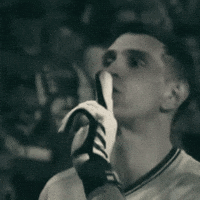 A Man Wearing A Nike Shirt Is Holding A Banana In His Hand GIF